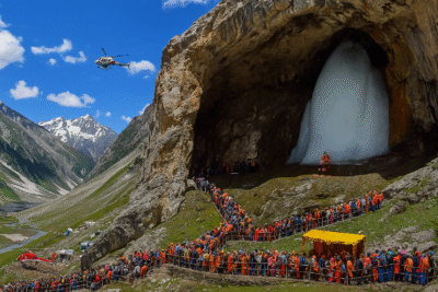 Why Amarnath Yatra is unique? Pilgrims trekking to the sacred Amarnath Cave with snow-covered mountains and the divine ice Shivling in the background.